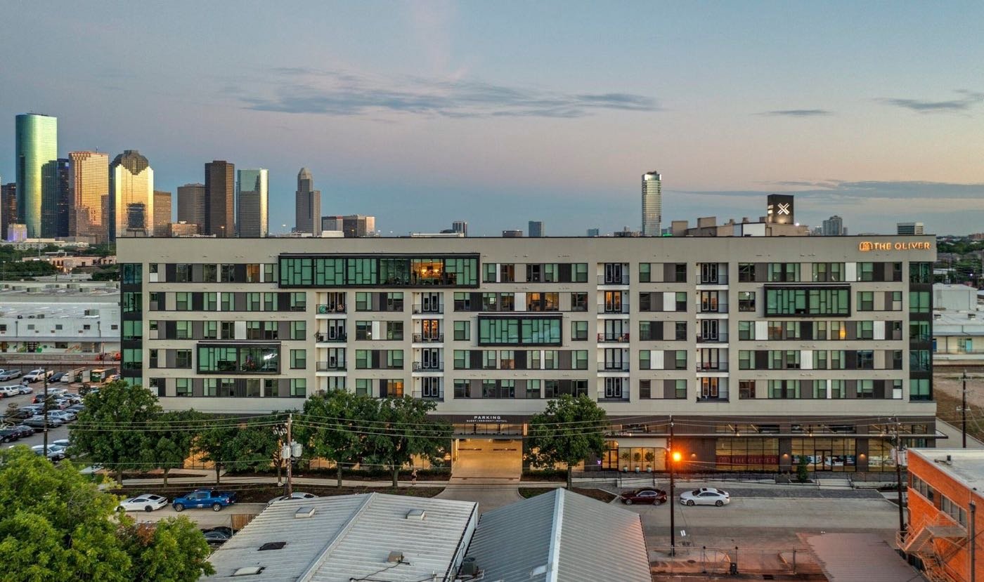 Multifamily building by MEEKS + Partners in Houston at dusk